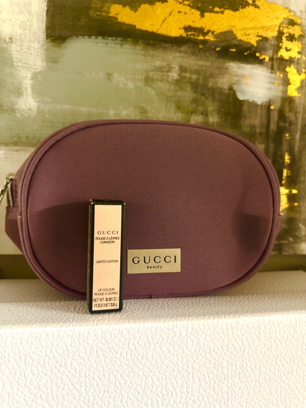 Gucci mauve oval cosmetic pouch with lipstick